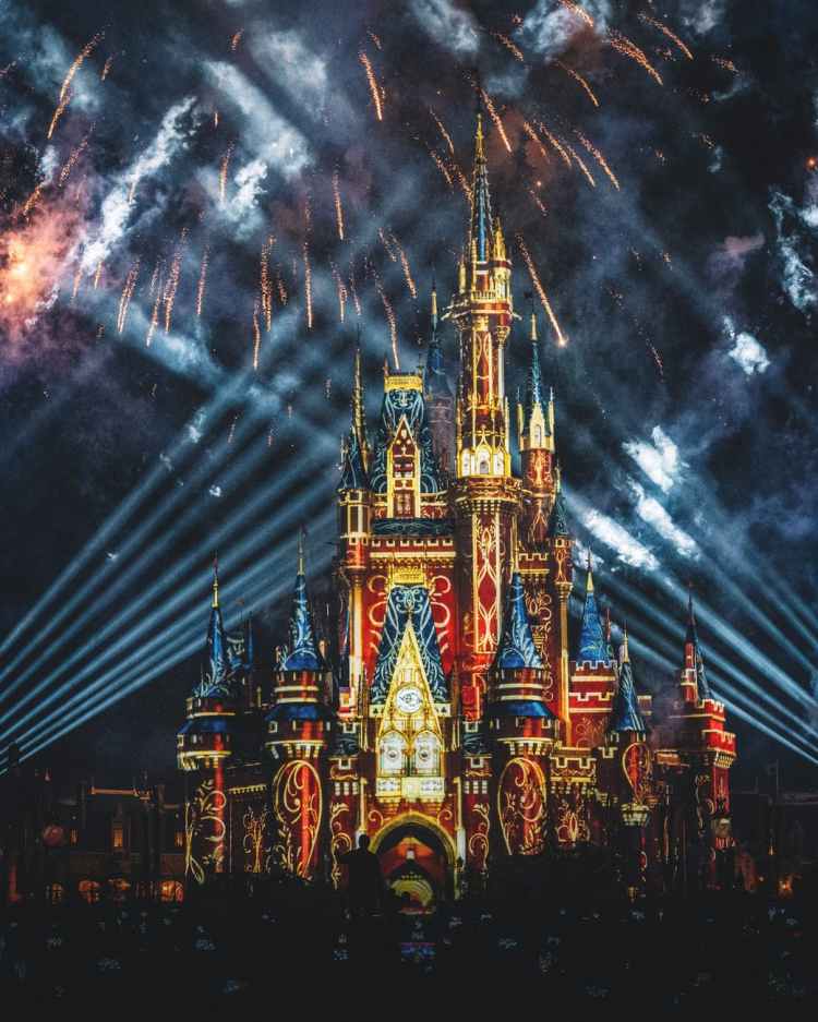 fireworks display above blue brown and red castle